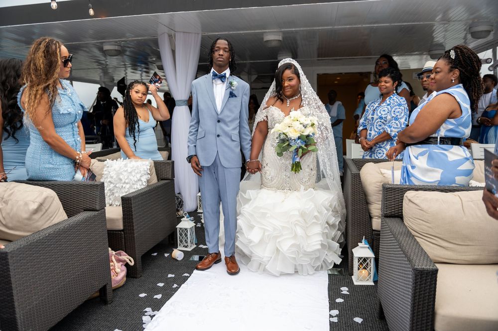 Bridesmaids holding bouquets with ocean view in background