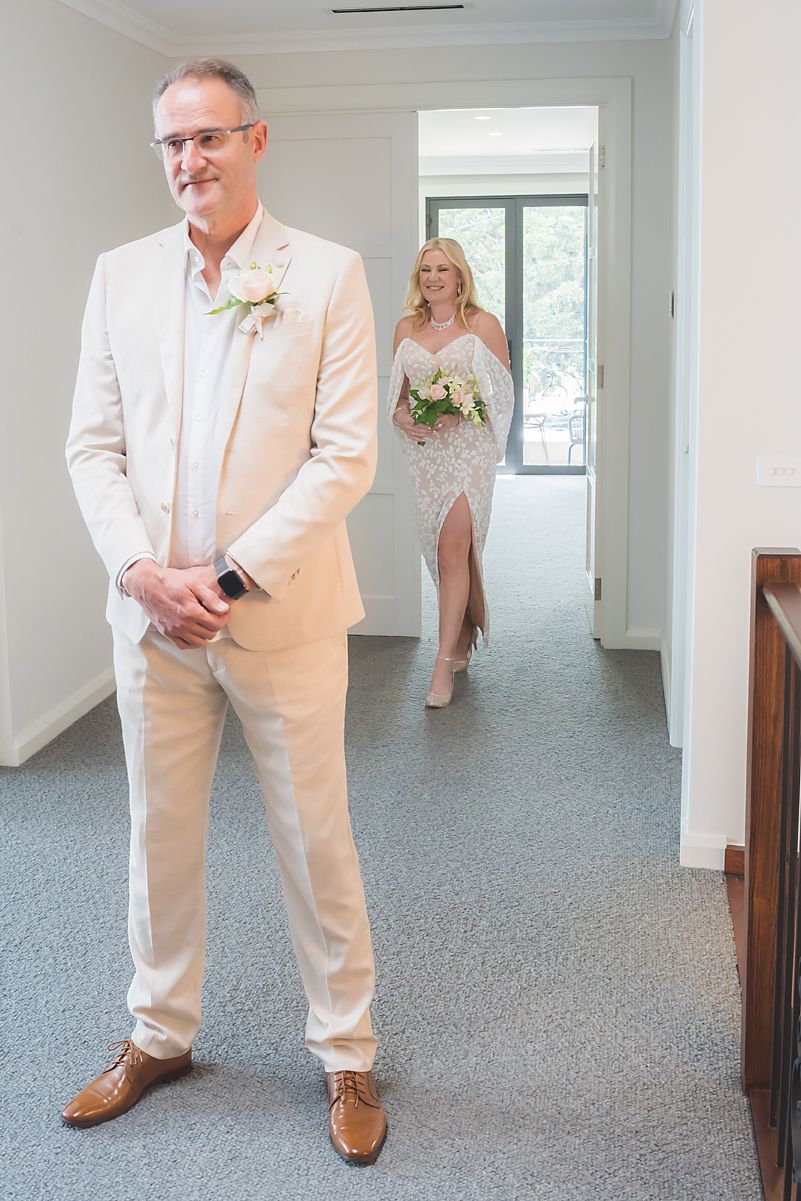 A collage of wedding photos showing a groom in a light beige suit with brown shoes standing in different poses.