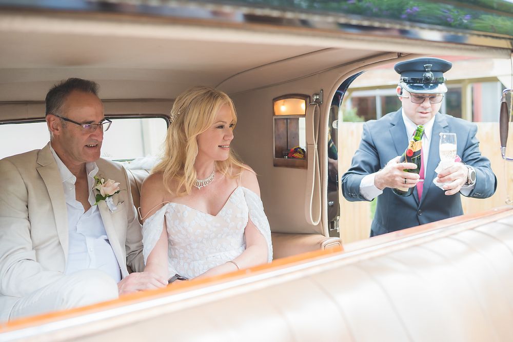 A series of five photos showing a couple in a vintage car on their wedding day set against an elegant country backdrop.