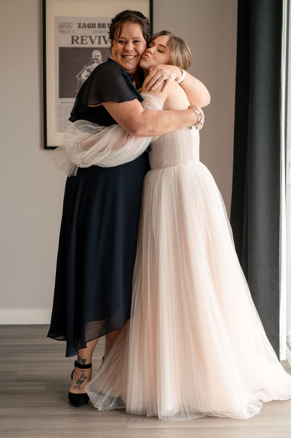 Tender moment captured as two people embrace during wedding celebration indoors Cambridge New Zealand