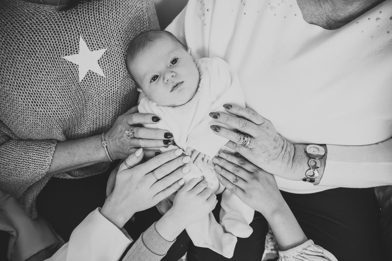 Intimate black and white photos of family members holding a baby. Photographer. Hull. East Yorkshire. Photography