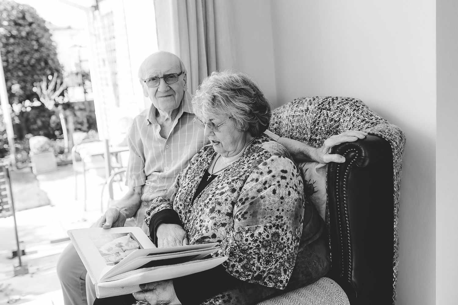 Black and white photos of couple sharing memories while seated indoors. Photographer. Hull. East Yorkshire. Photography