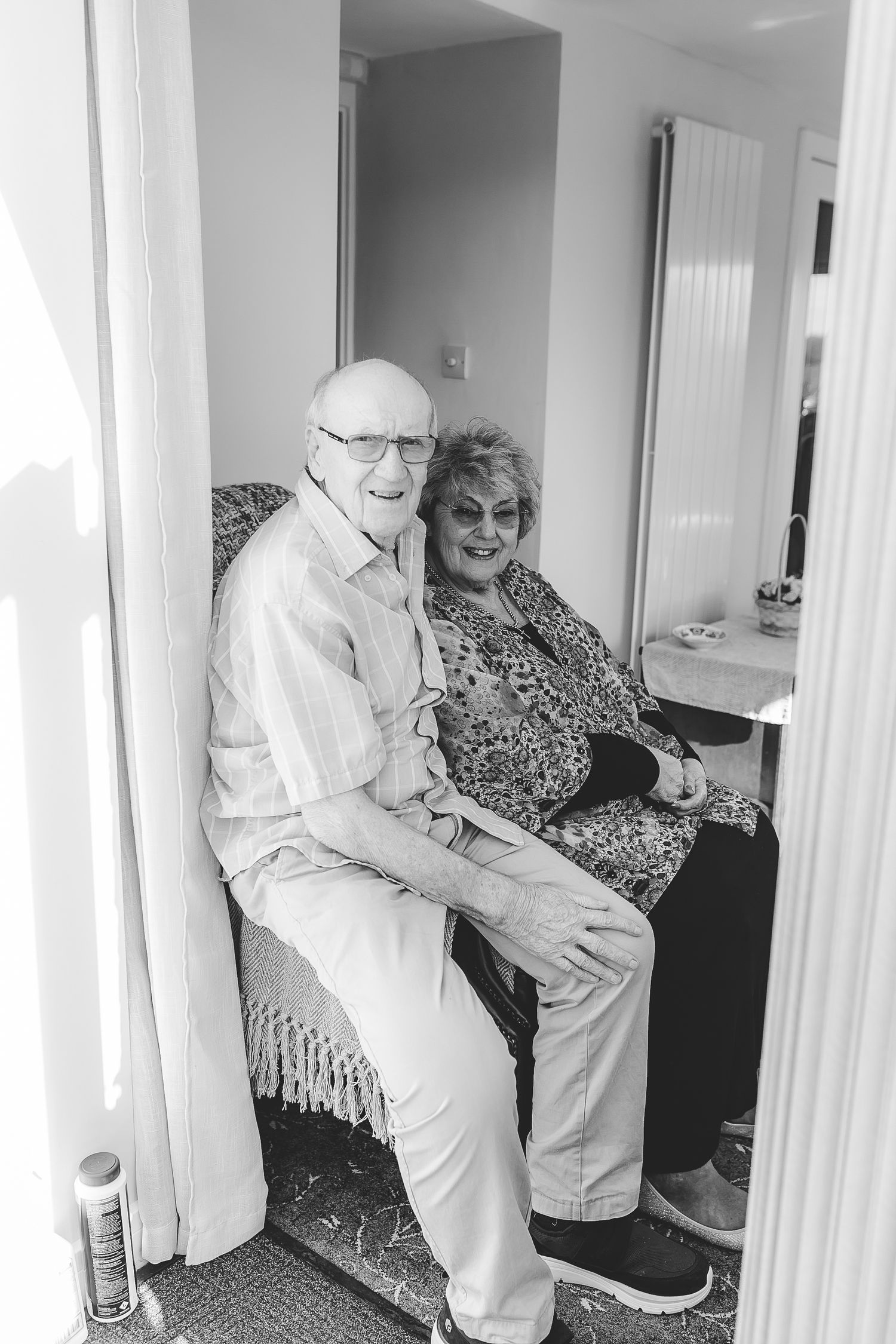 Elderly couple sharing a tender moment together while sitting indoors. Photographer. Hull. East Yorkshire. Photography