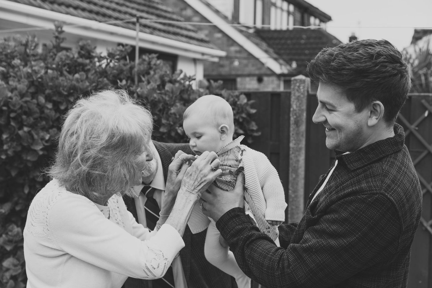 Black and white photo of family members playfully covering their eyes. Photographer. Hull. East Yorkshire. Photography