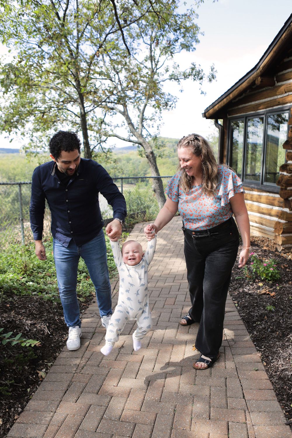 Family of 3, swinging the 1-year-old