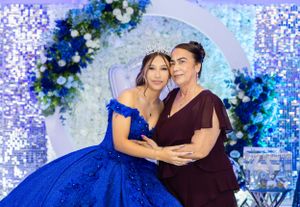 Intimate portrait against a floral arch background with blue mood lighting.