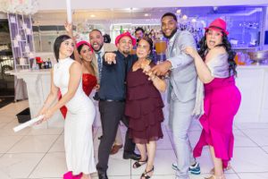 Group of party guests pose together at formal event.