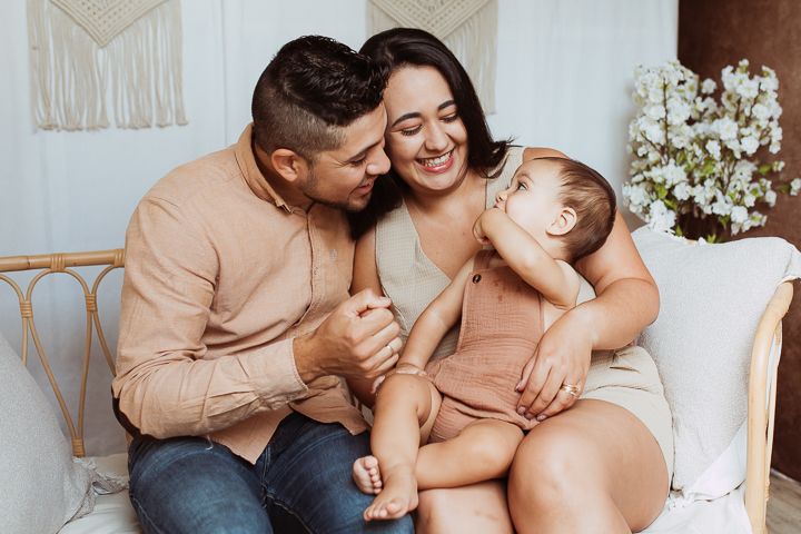 Intimate family photos showing tender moments between parents and baby.
