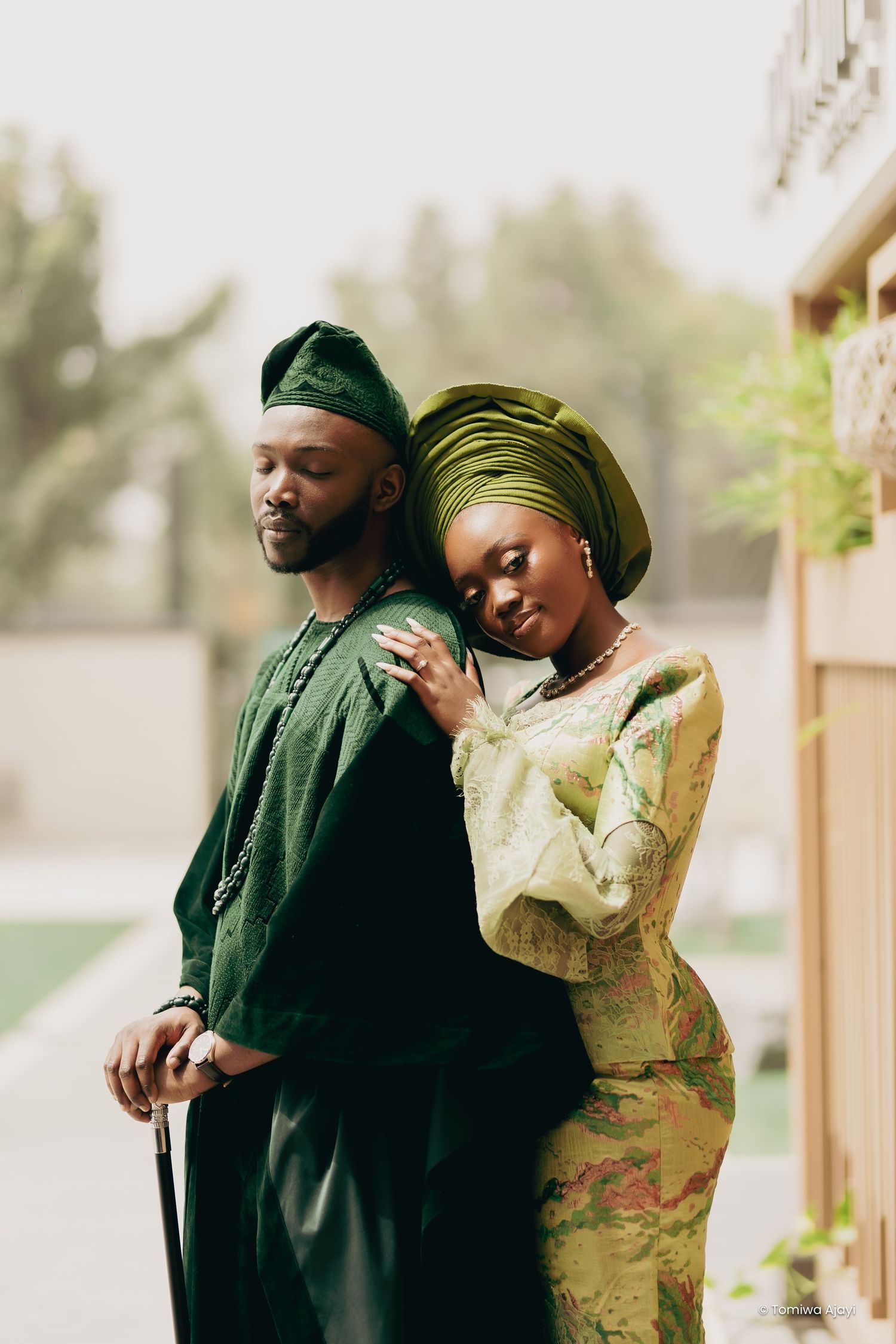 A couple in contrasting green and yellow outfits share intimate moments in a series of outdoor portraits.