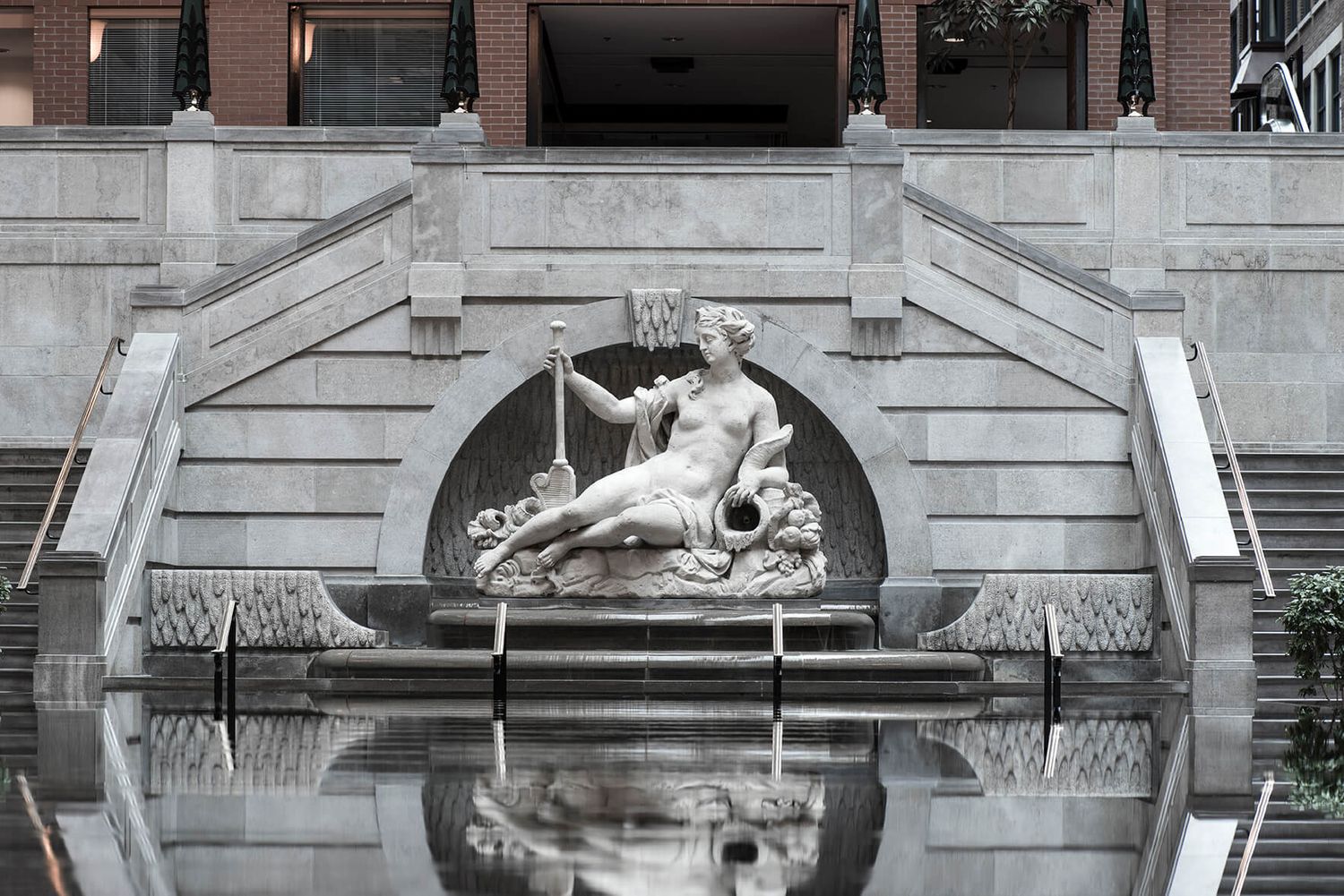 Architectural detail of classical stone building with ornate carvings and decorative elements.