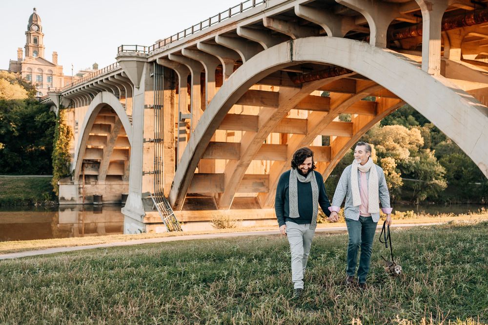 two gay men holding hands walking towards the camera during a LGBTQ friendly portrait session in downtown Fort Worth