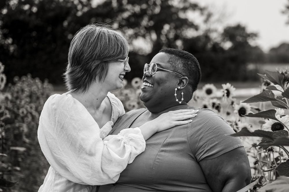Lesbian couple posing nose to nose during a lgbtq friendly maternity session in Aubrey Texas