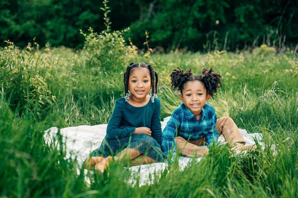 two children with special needs smiling and laughing during an outdoor family photoshoot in Fort Worth Texas