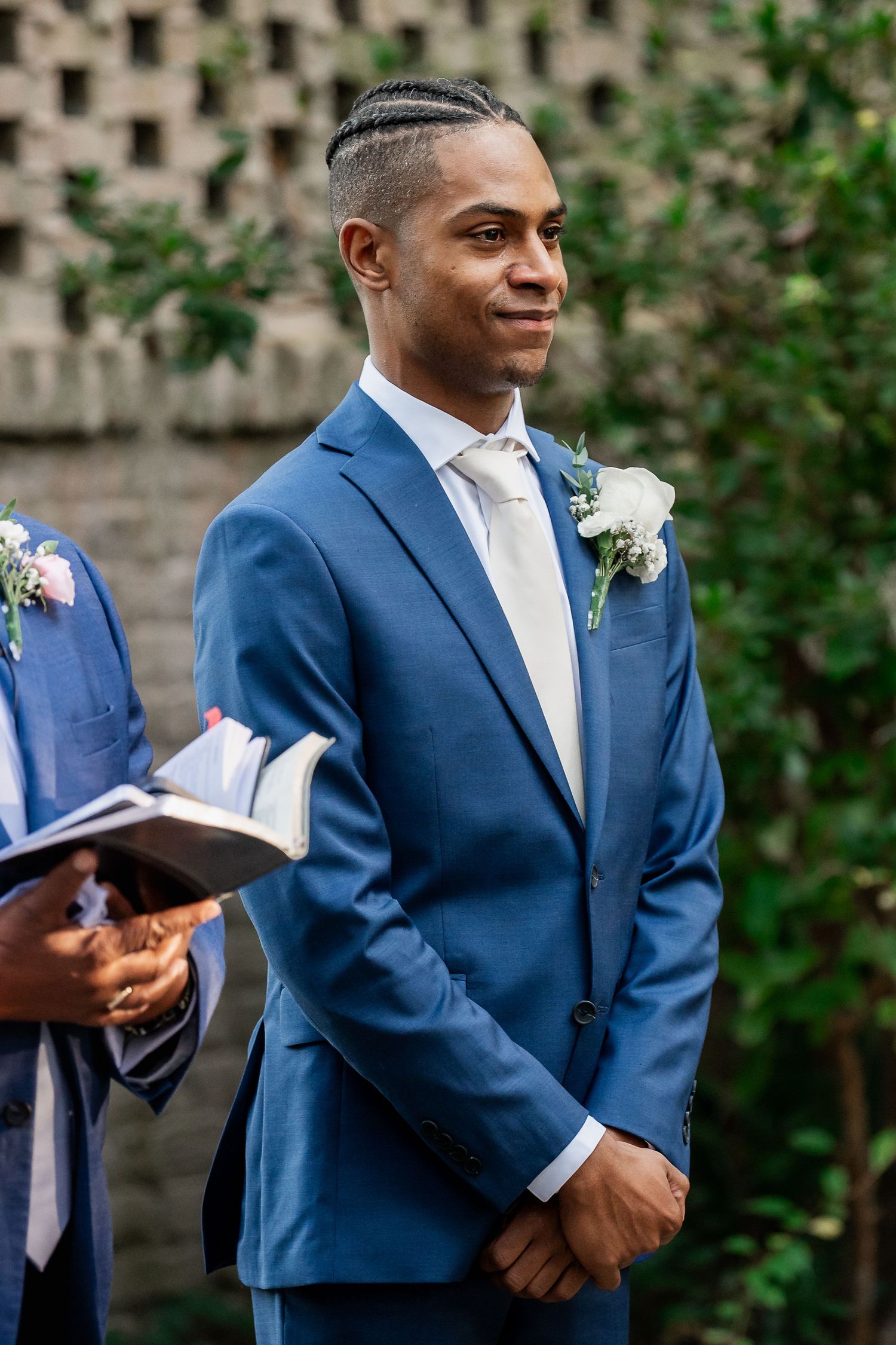 Groom watching bride walk down the aisle