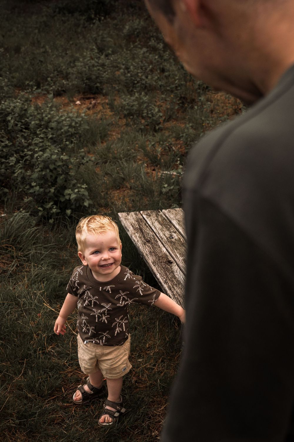 A sequence of playful moments captured in moody outdoor portraits with dark brown tones and natural lighting.