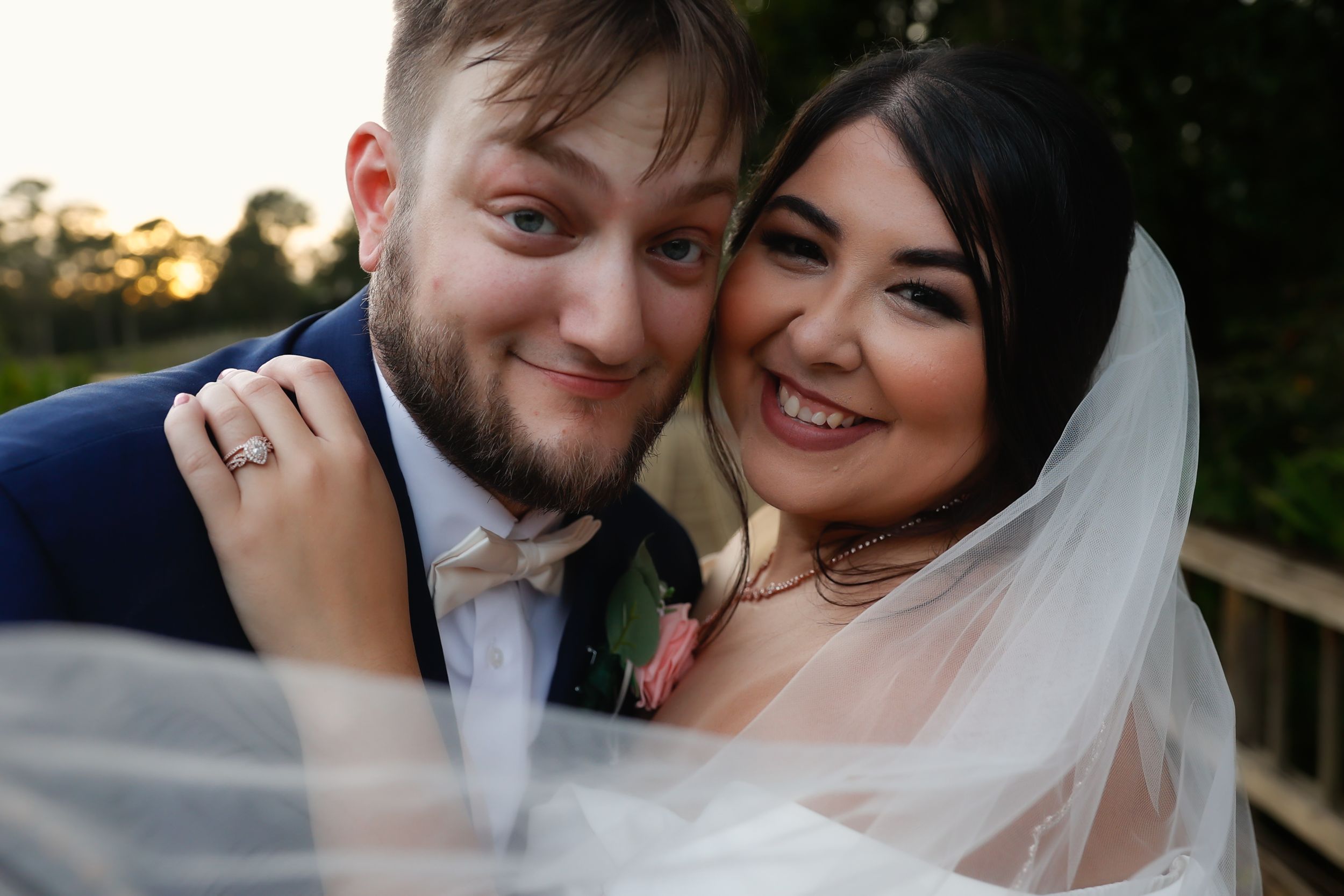 A bride and groom share intimate moments in a series of romantic outdoor wedding photos at sunset.