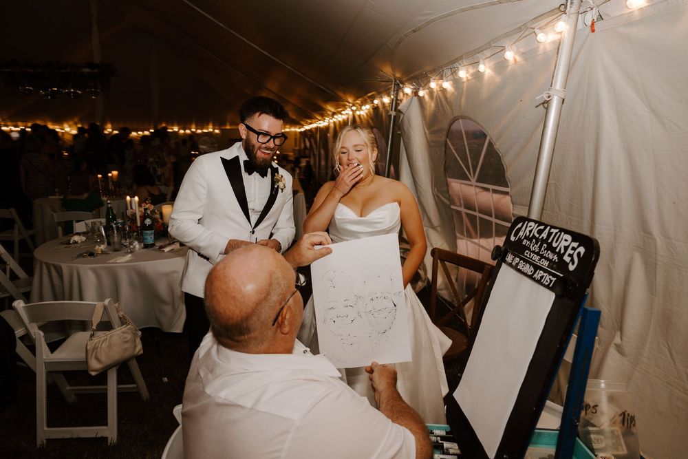Wedding reception photos under string lights with guests holding up signs during a game or activity.