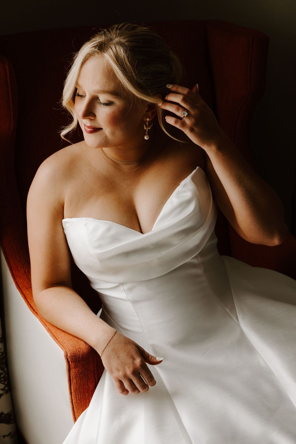A series of close-up shots showing the elegant details of a white strapless wedding dress against a dark background.