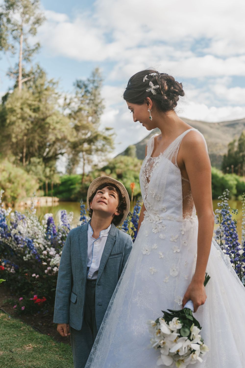 Ring bearer looks up at the bride.