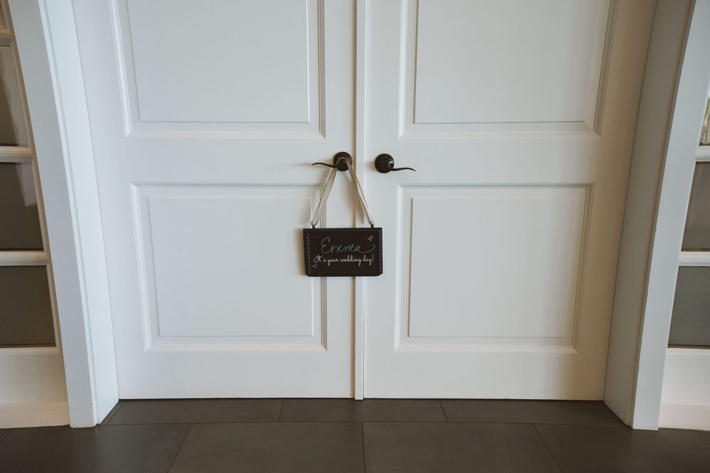 White paneled interior doors with brass door handles and knobs in a modern hallway setting.