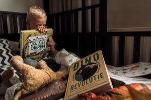 Books and reading materials arranged on dark wooden table.