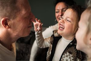 Candid moments of joy and laughter captured in moody lighting.