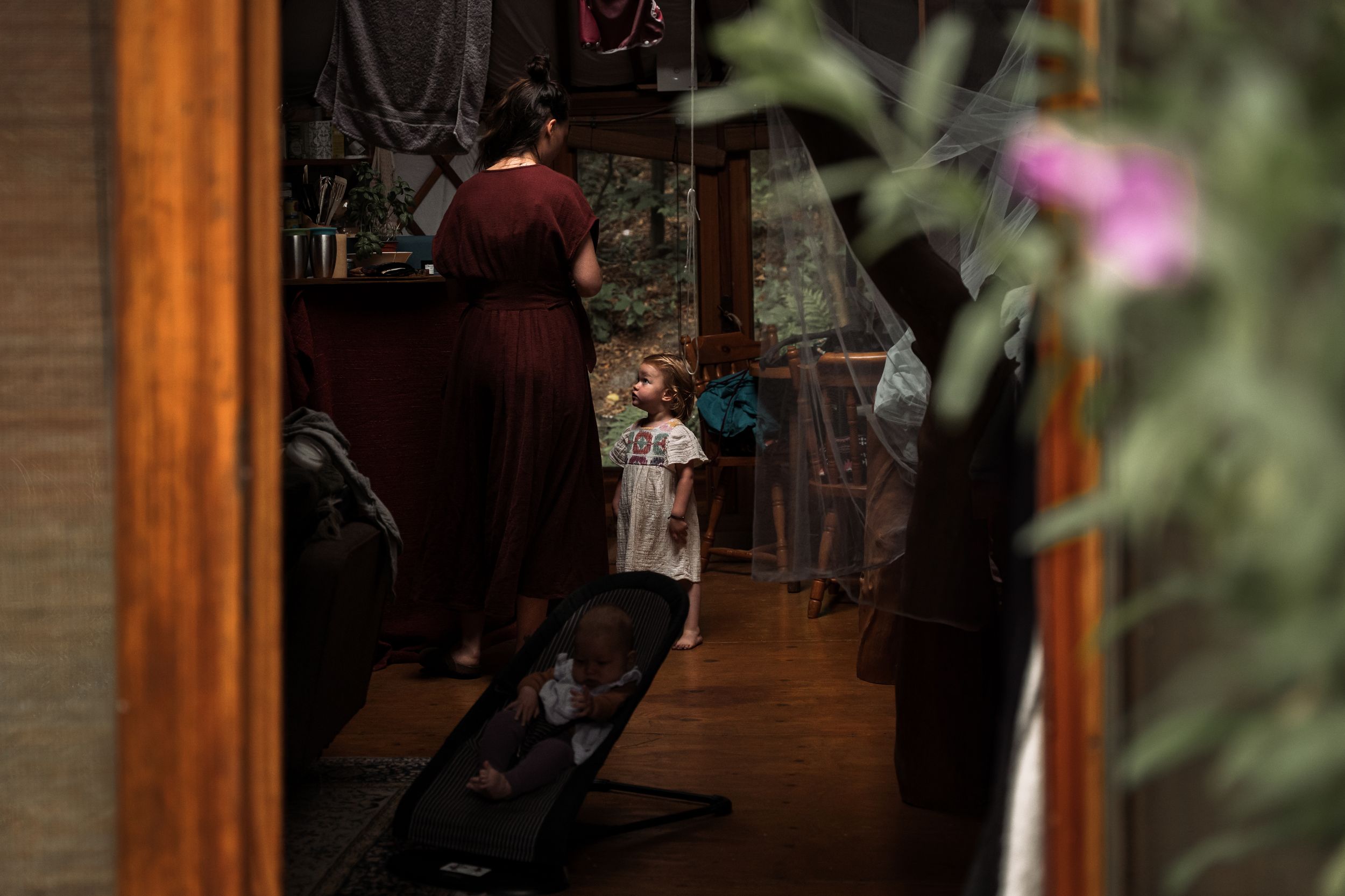 Dimly lit hallway with rustic wooden beams and soft ambient lighting creating a cozy atmosphere.