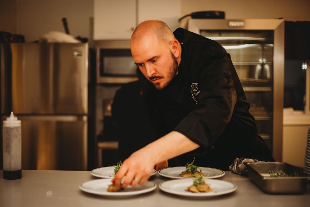 Chef Aaron from Aaron Charles Catering preparing a dish at a multi-course dinner event near Port Perry, Ontario.