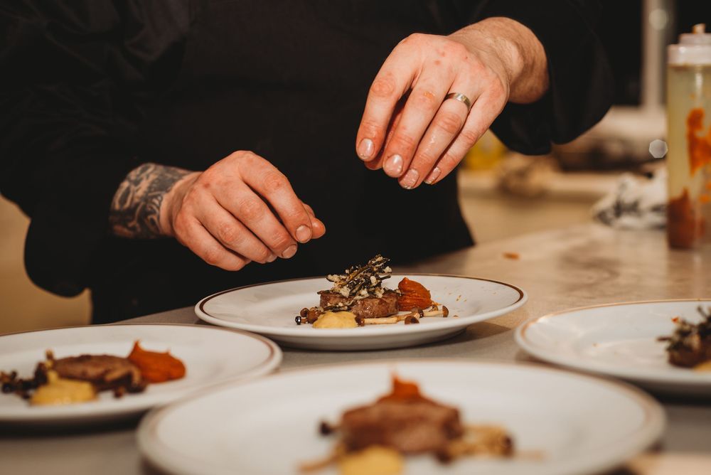 A chef preparing a dish at a multi-course dinner event near Port Perry, Ontario.