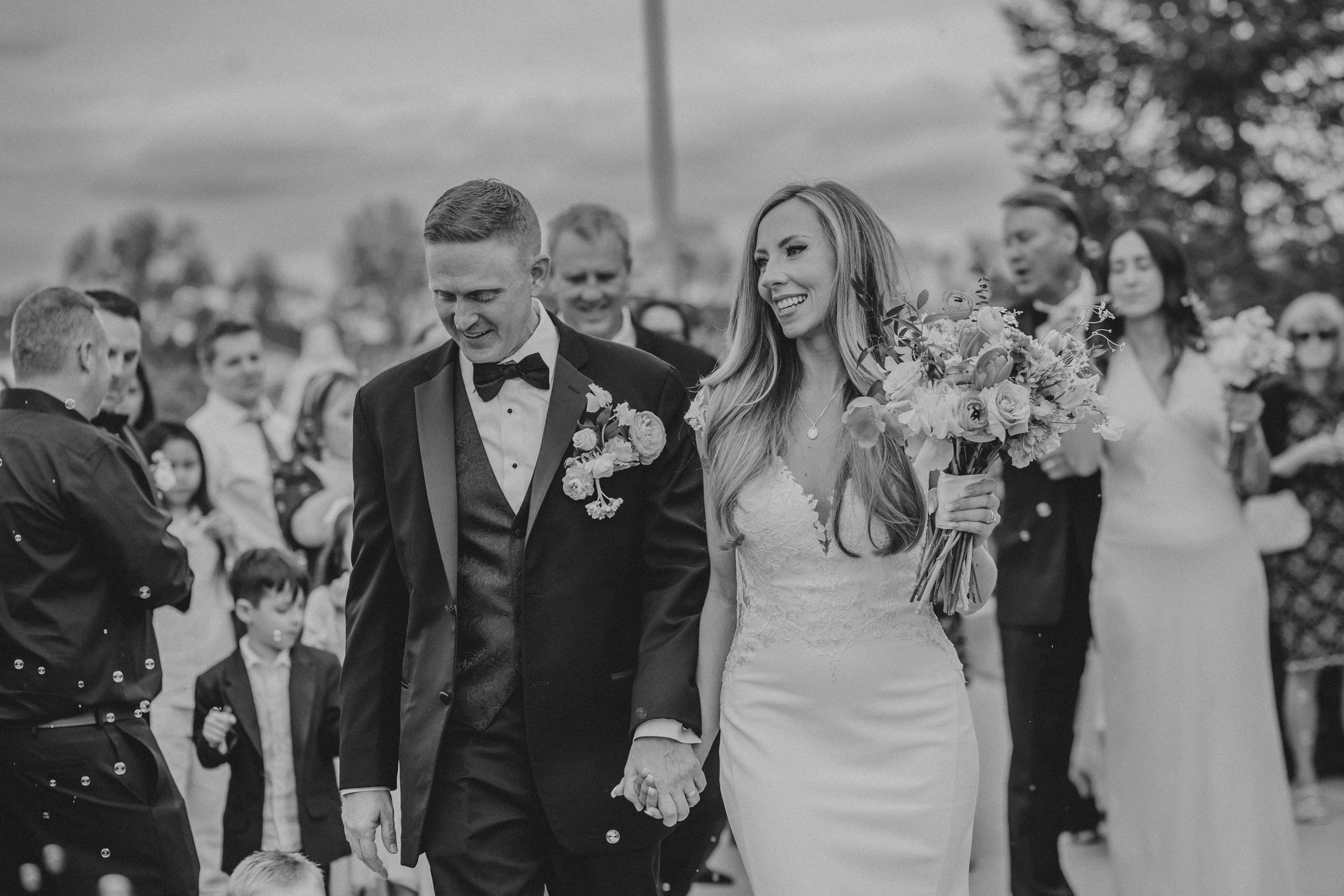 A black and white wedding photo collage showing candid moments of celebration and ceremony.