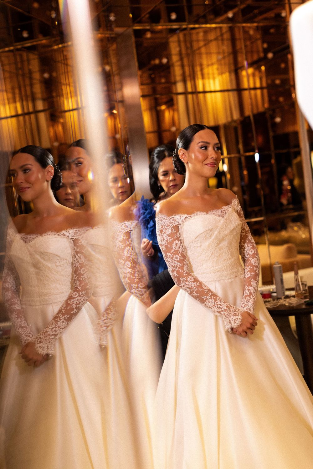 Multiple views of an elegant bride in a white wedding gown with lace details in a warmly lit indoor venue.