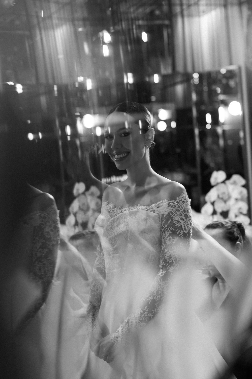 A black and white photo sequence showing blurred motion of dancing at a wedding reception.