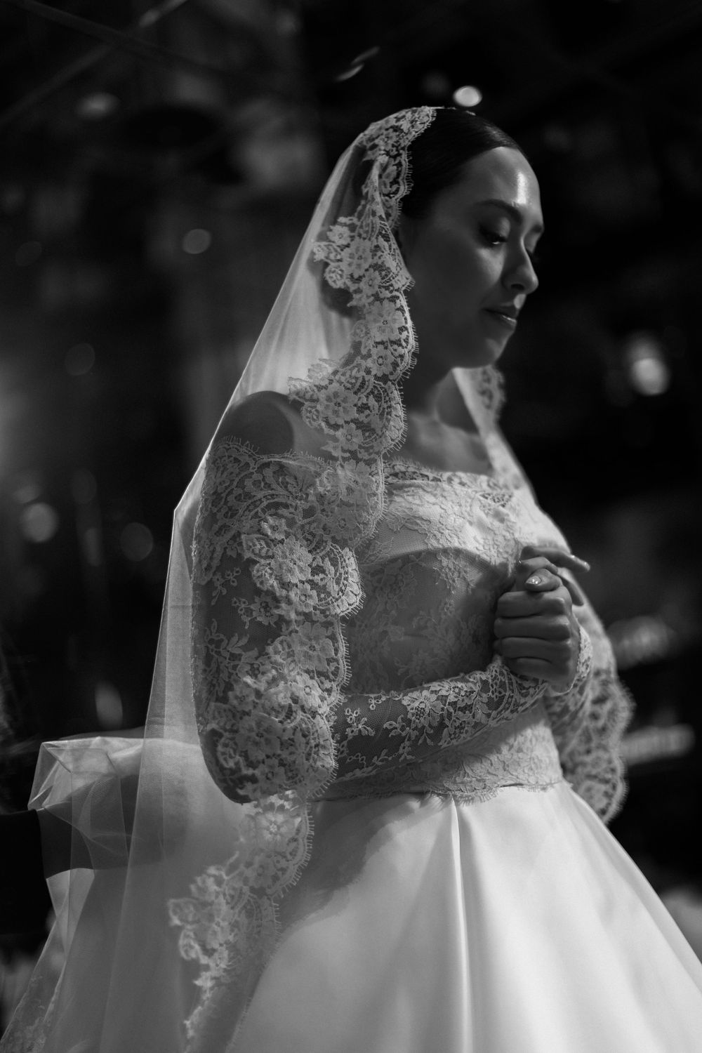Black and white artistic shots of a bride's lace veil and wedding dress details.