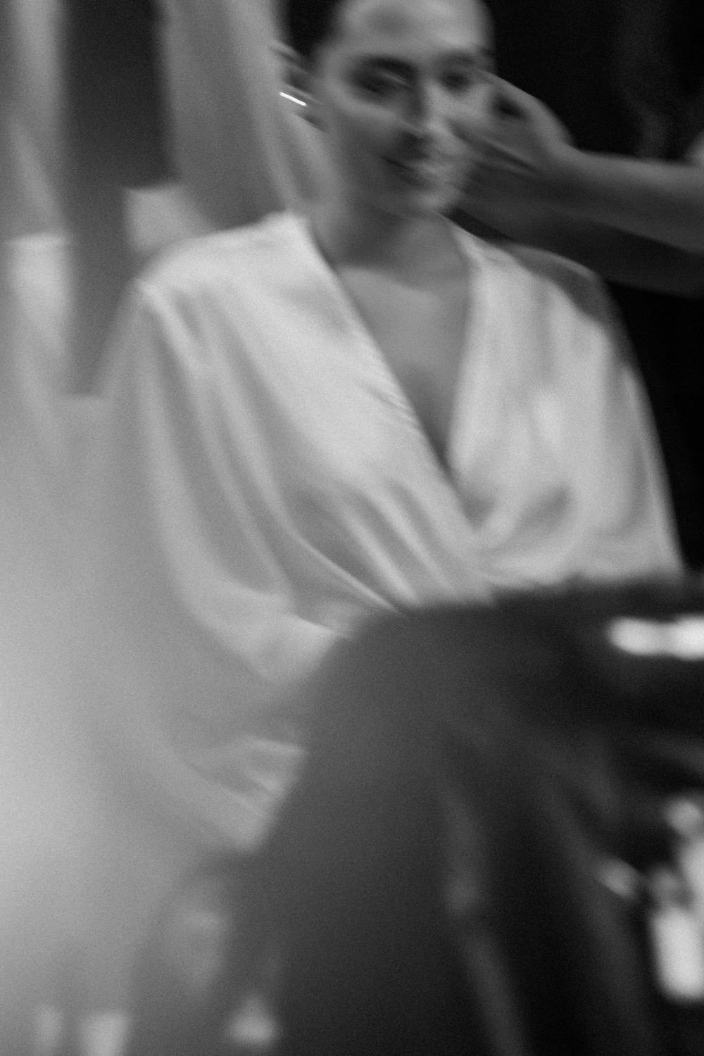 Blurred black and white image of wedding preparation moments.
