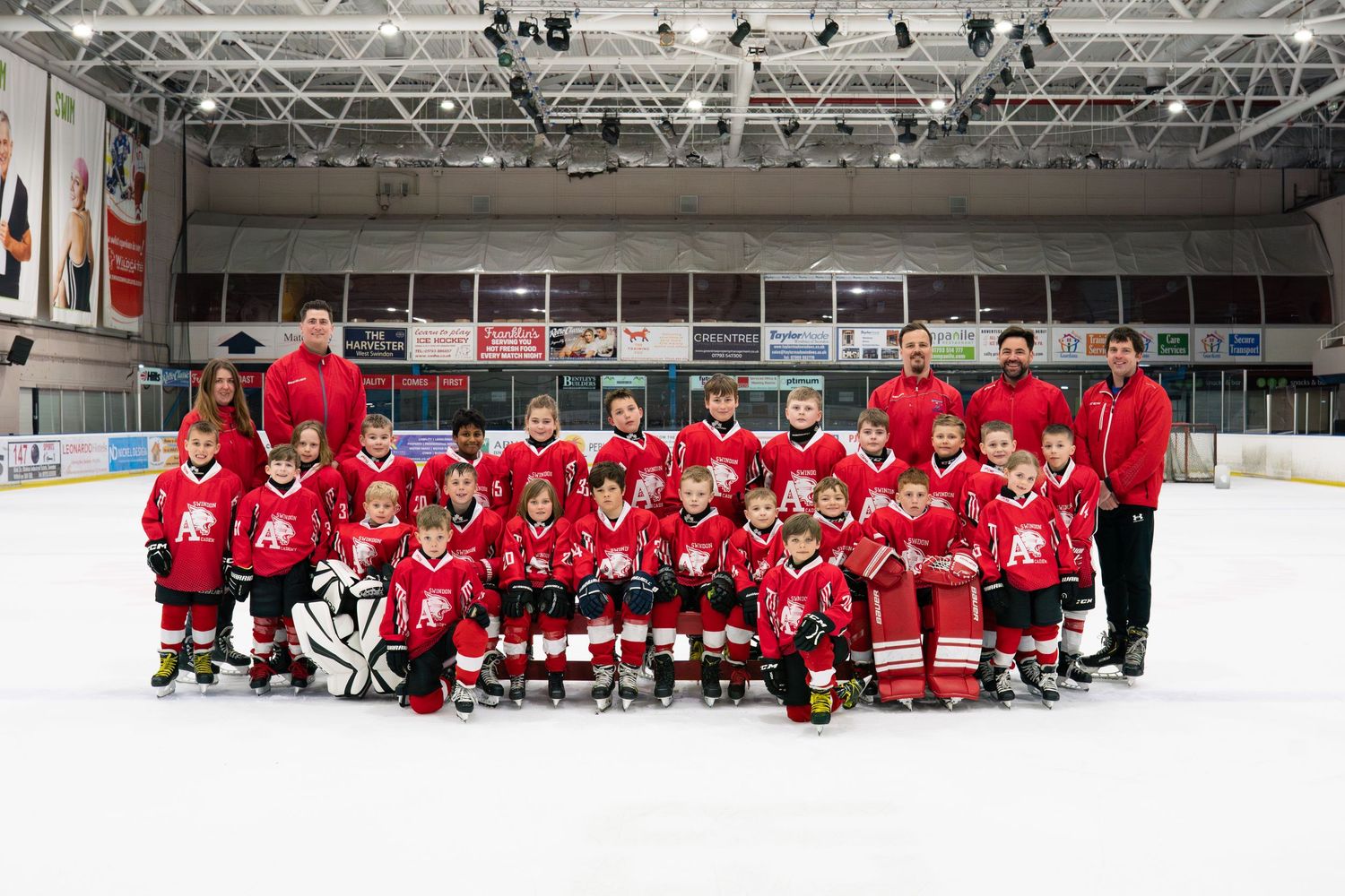 Sports photography of a junior ice hockey team group portrait in an arena