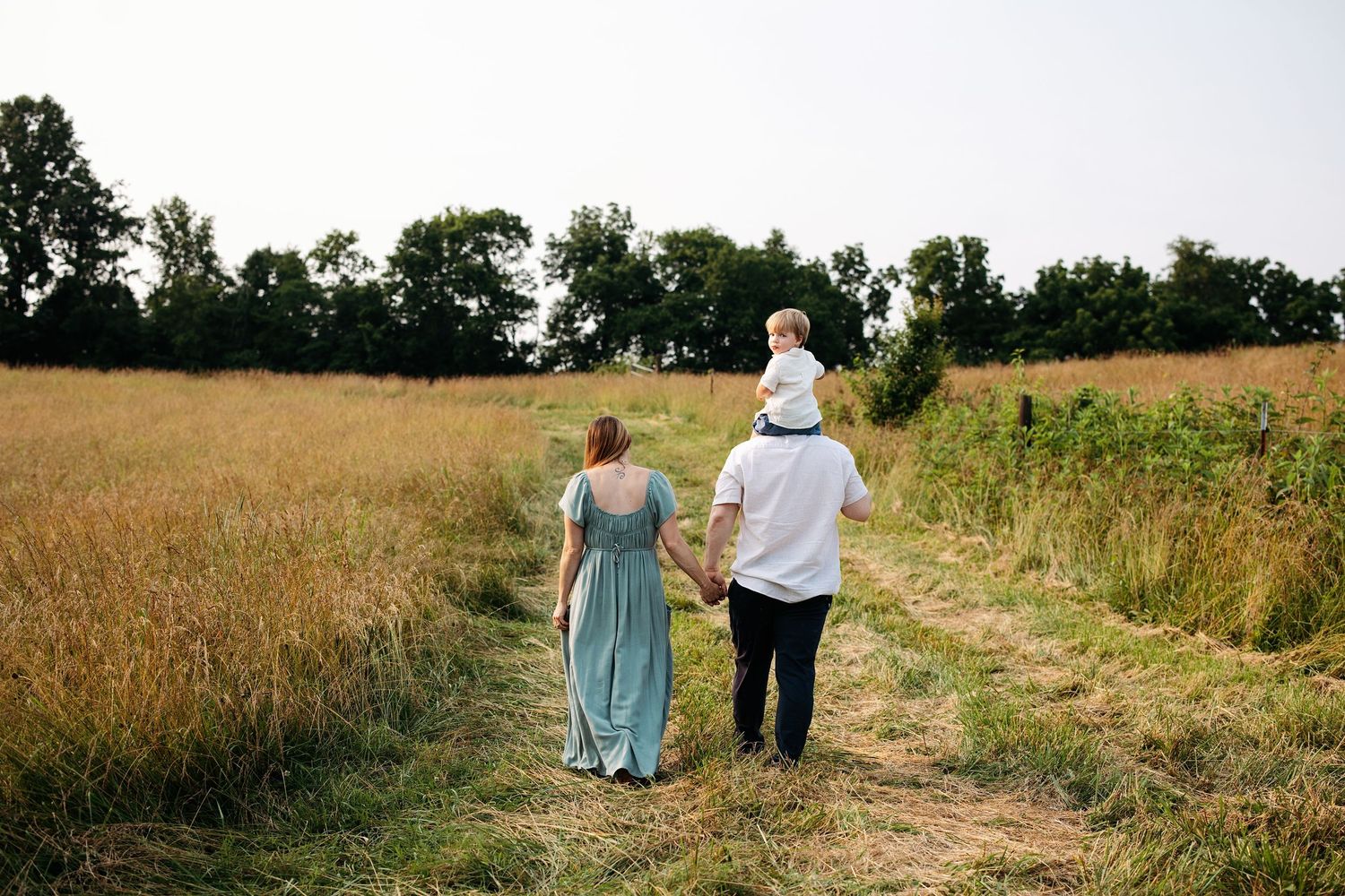 Family maternity photoshoot in field in middle Tennessee.  Professional outdoor maternity photos.