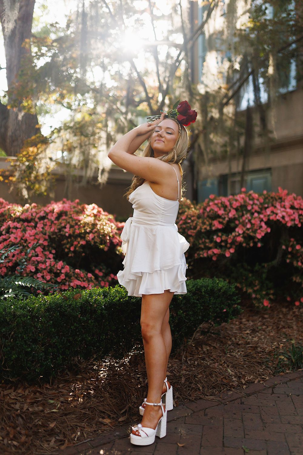 A series of photos showing a white summer dress against a backdrop of pink azalea bushes and trees.