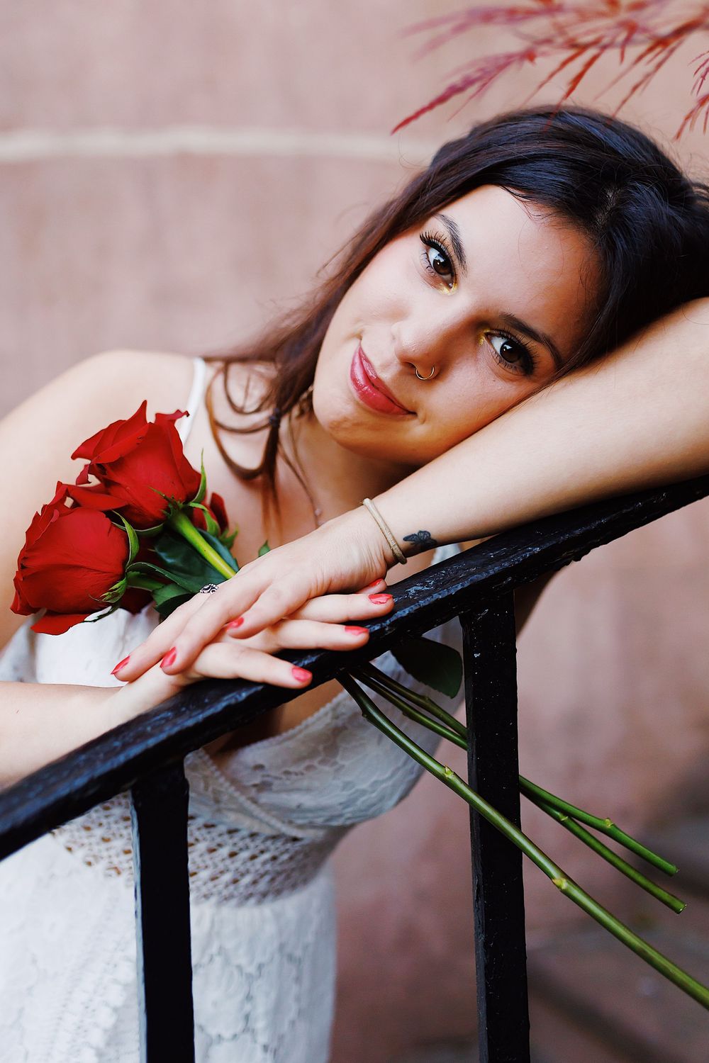 A series of artistic portrait shots featuring a red rose and soft lighting against a neutral background.