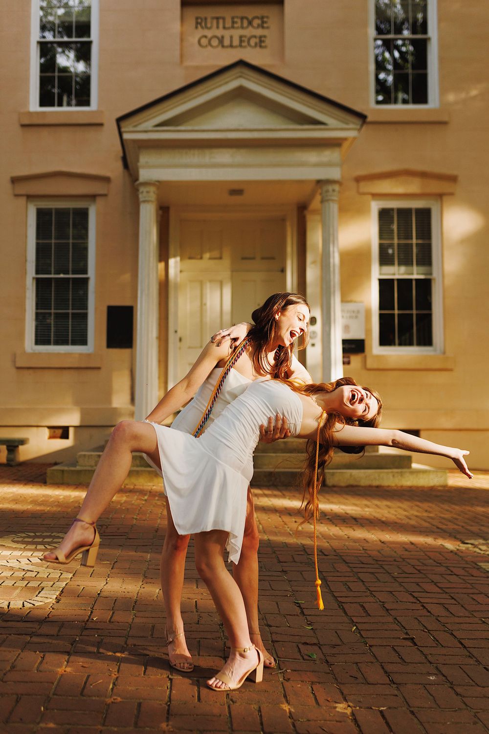 A series of artistic dance poses captured at sunset against a brick walkway and classical college building exterior.