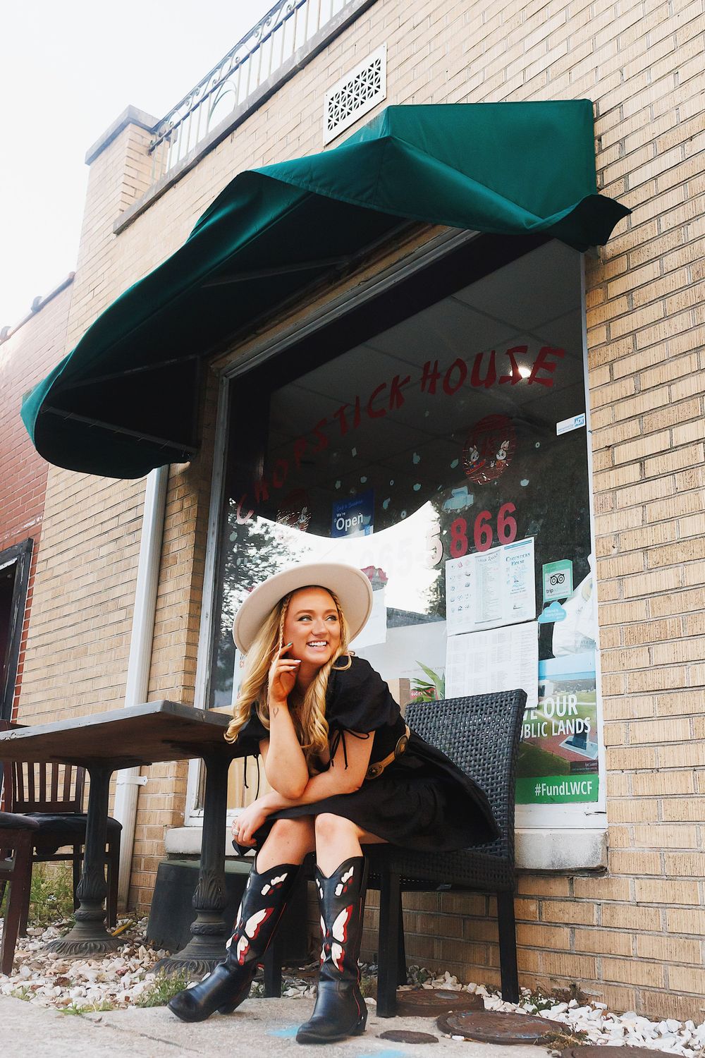 A series of outdoor shots under a green awning against a brick wall with black bench seating.