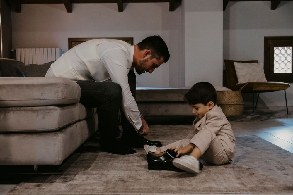 Interior scene showing someone arranging items on a plush carpet.