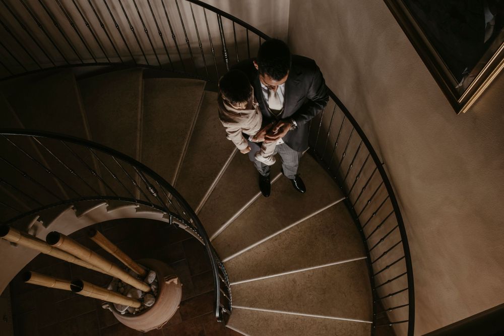 Spiral staircase view of an indoor event space with ambient lighting.