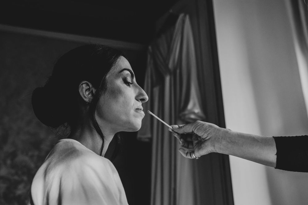 Black and white wedding preparation photos with dramatic lighting.