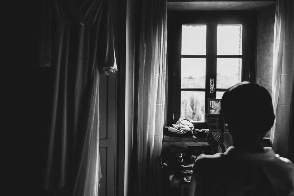 Dark silhouette near window with dramatic natural lighting.