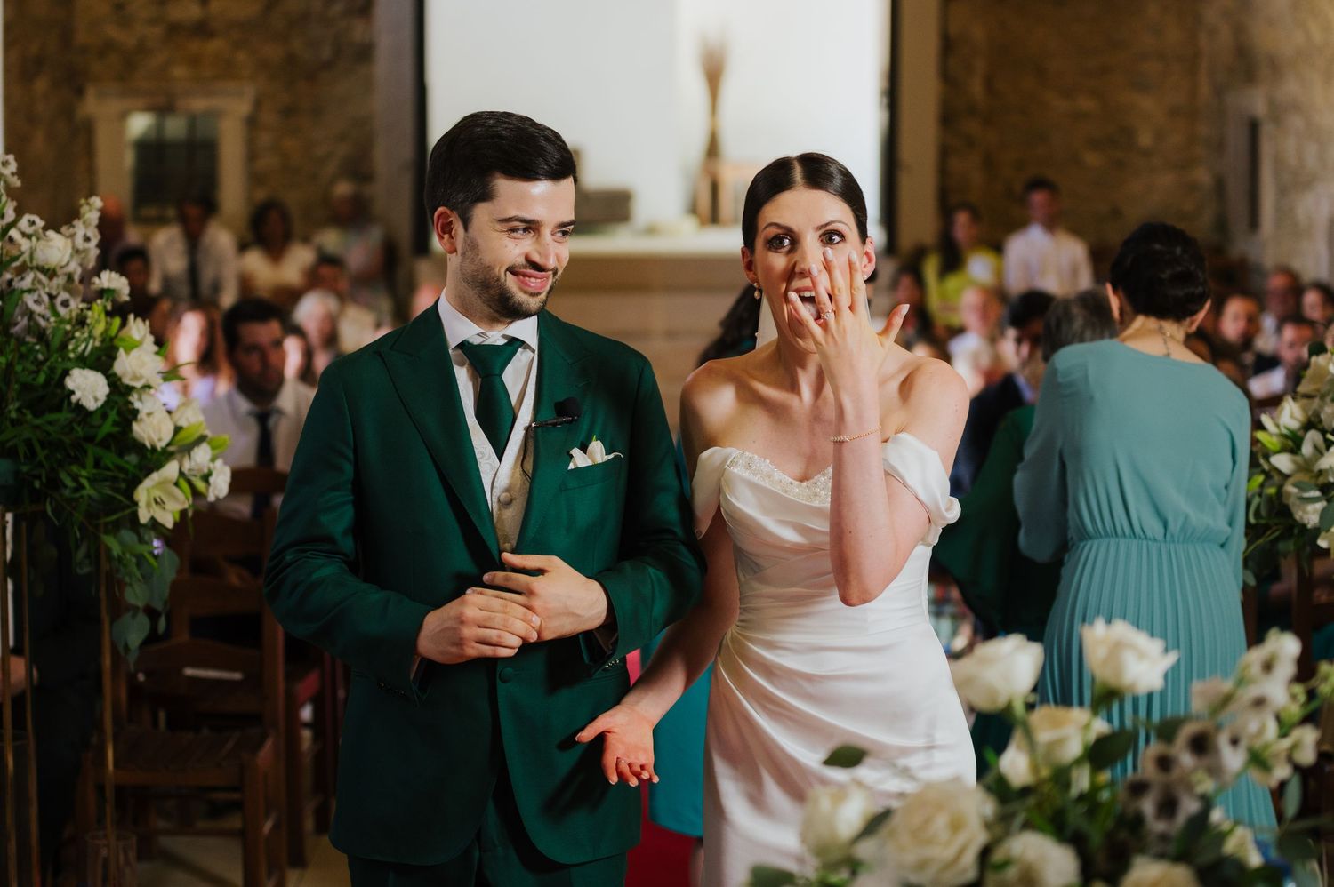 Romantic wedding photography in a lush green forest setting with natural sunlight filtering through trees.