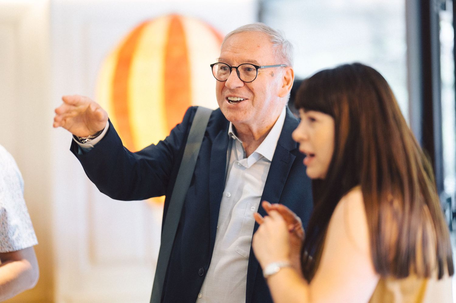 Business colleagues engage in animated conversation during a bright office meeting.