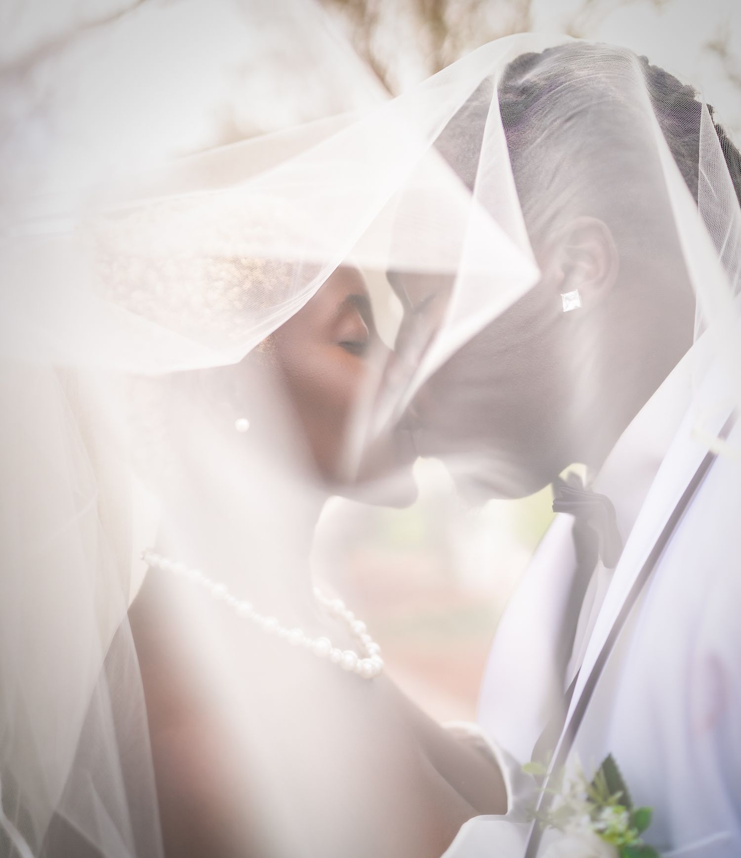 Couple sharing a kiss on a private yacht in Fort Lauderdale, captured by wedding photographers specializing in oceanfront events.
