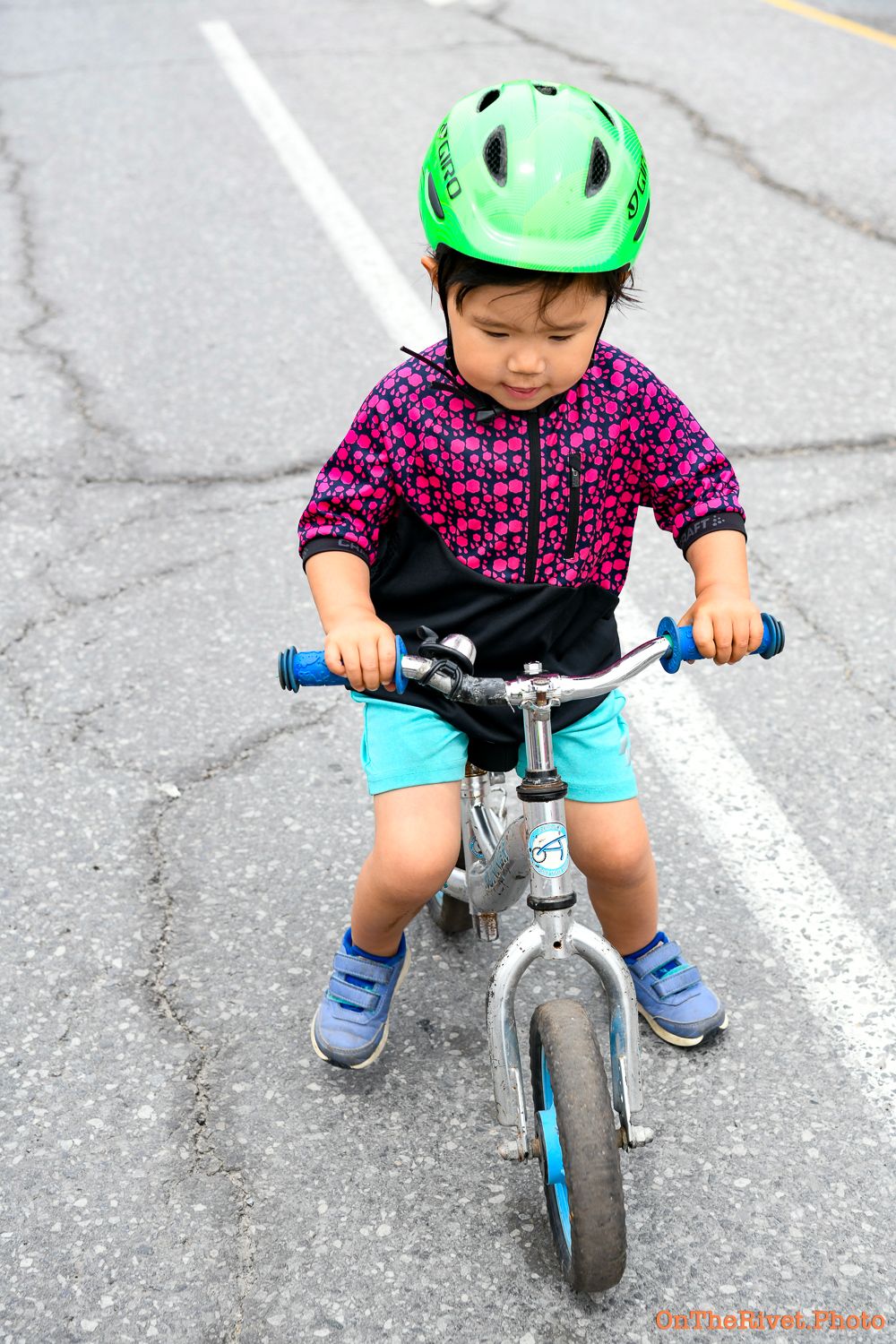 child on a strider bike