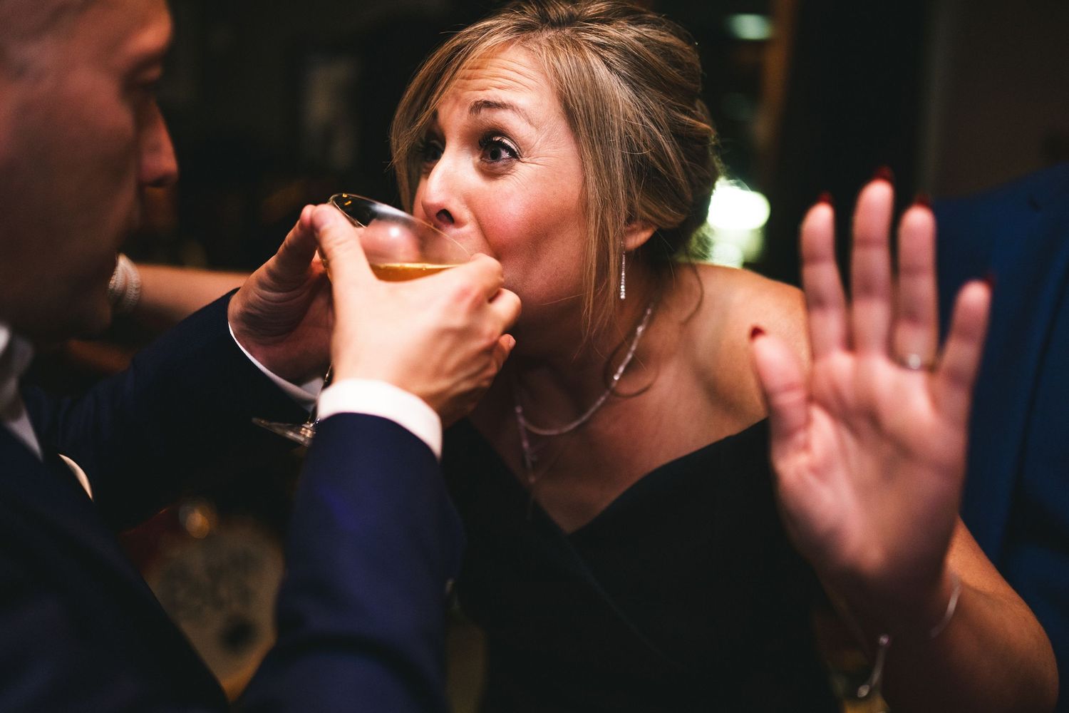 A heartfelt moment captured at a romantic candlelit dinner as someone feeds dessert to their dining companion.