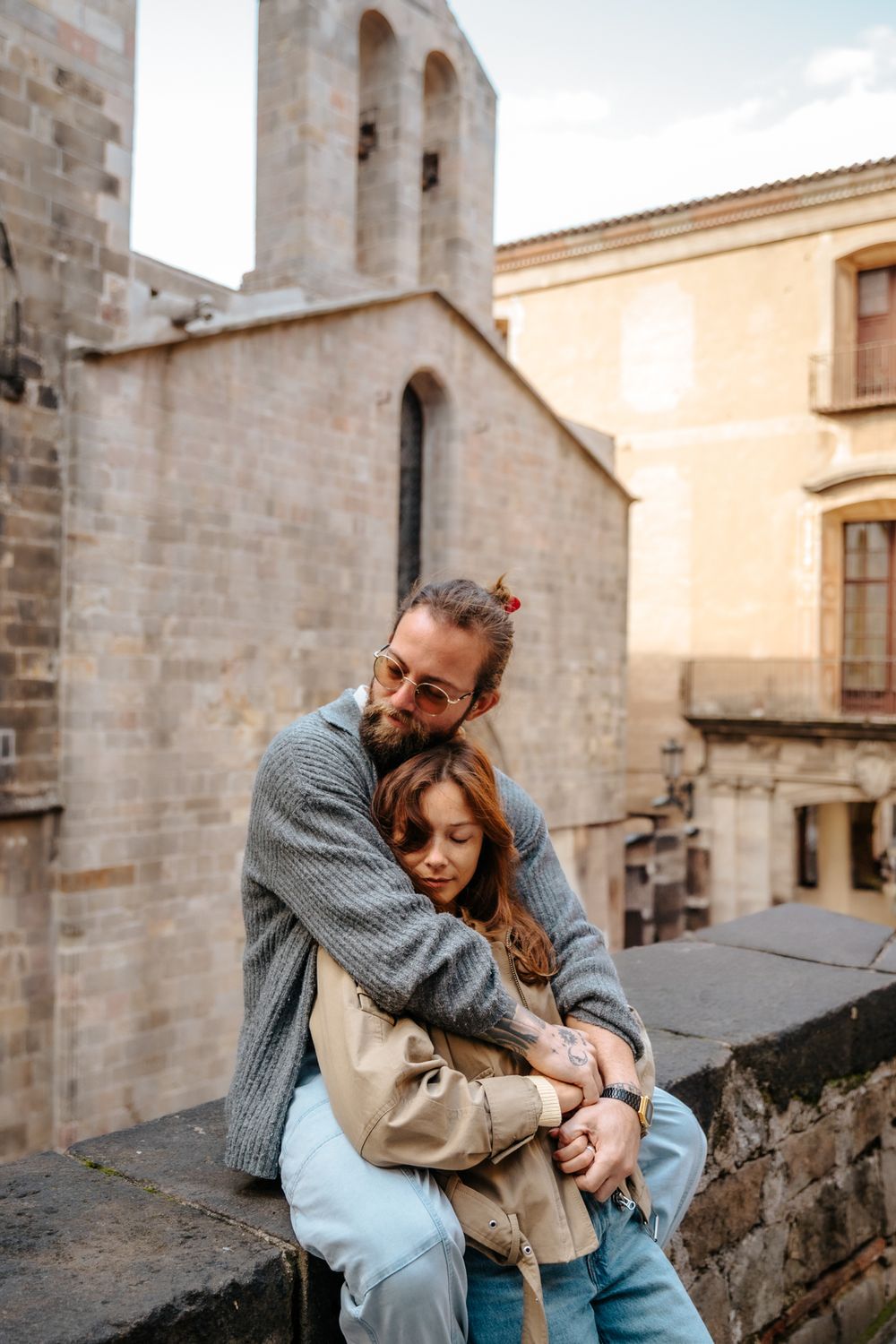 Tender kiss shared beneath ivy-covered walls in the Gothic Quarter.